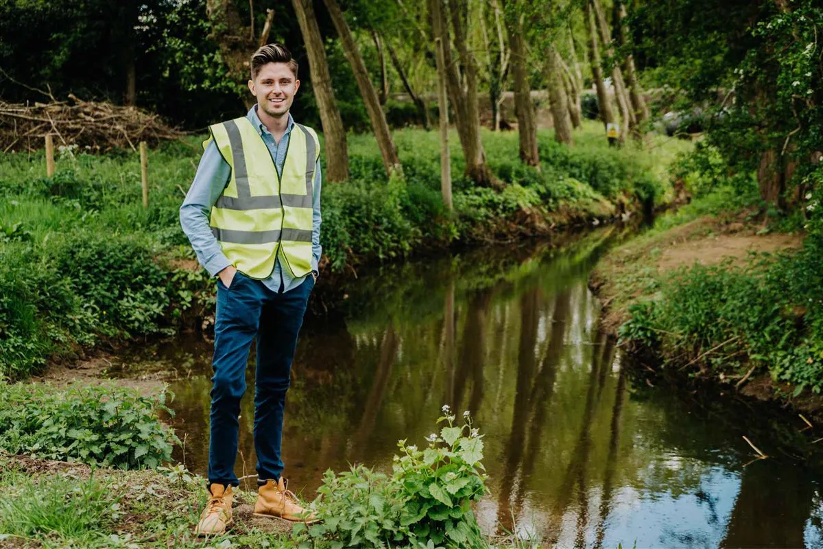 Simon Crowther on a riverbank during a site inspection