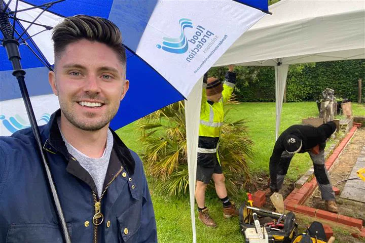 Simon Crowther on site with contractors during garden drainage works